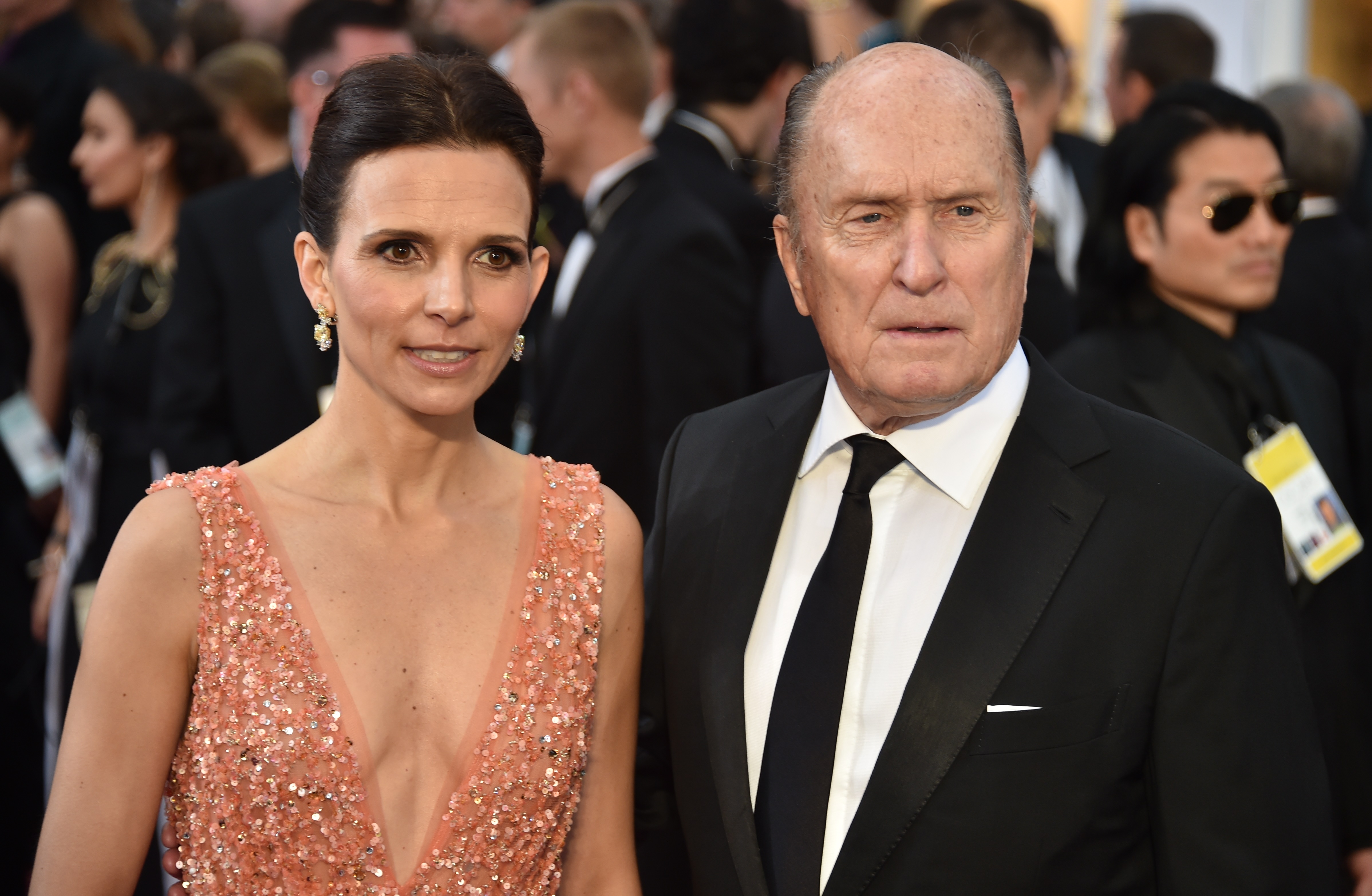 Robert Duvall and Luciana Pedraza on the red carpet at the 87th Oscars.