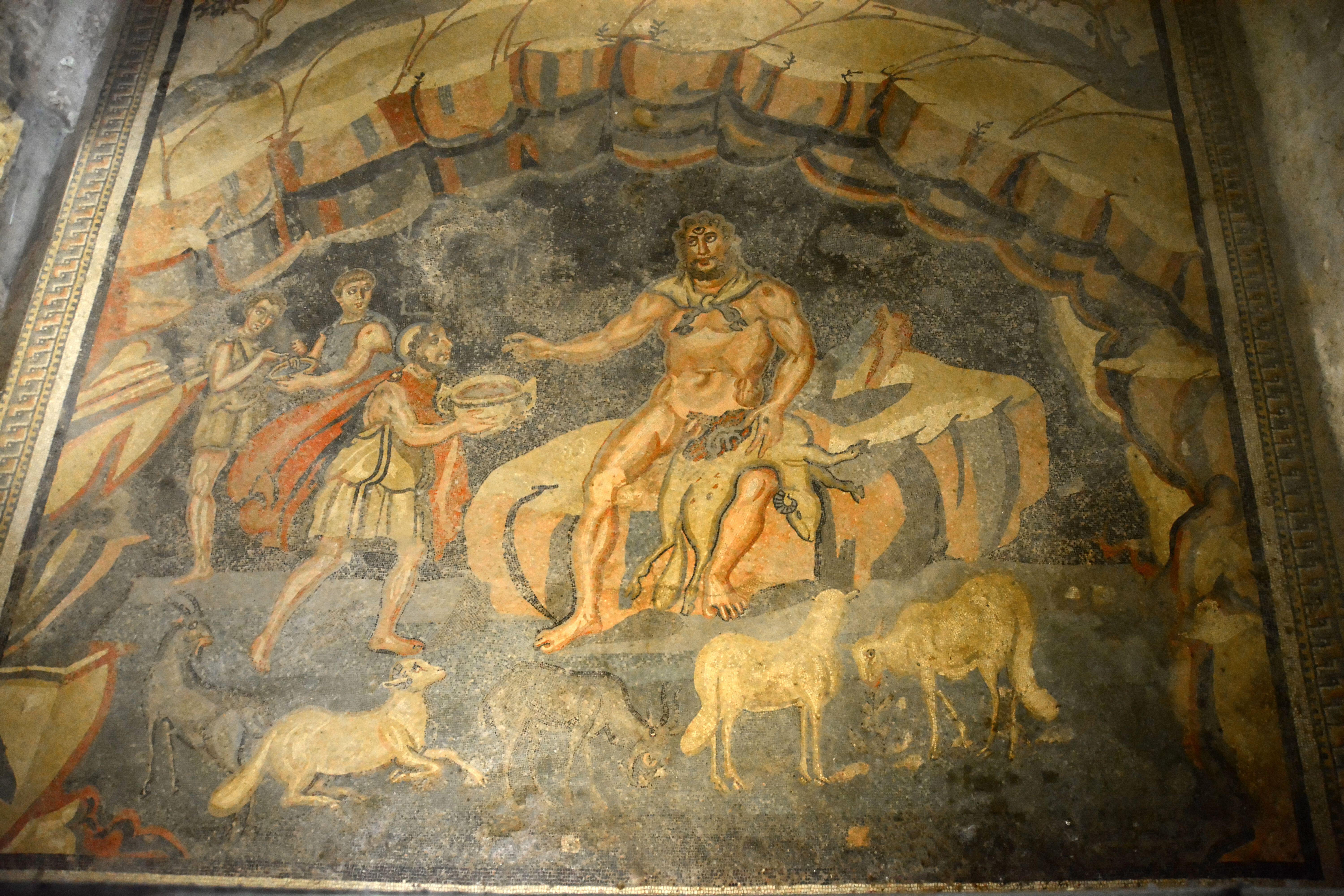 Ancient Roman mosaic showing Odysseus getting the Cyclops Polyphemus drunk in his cave.