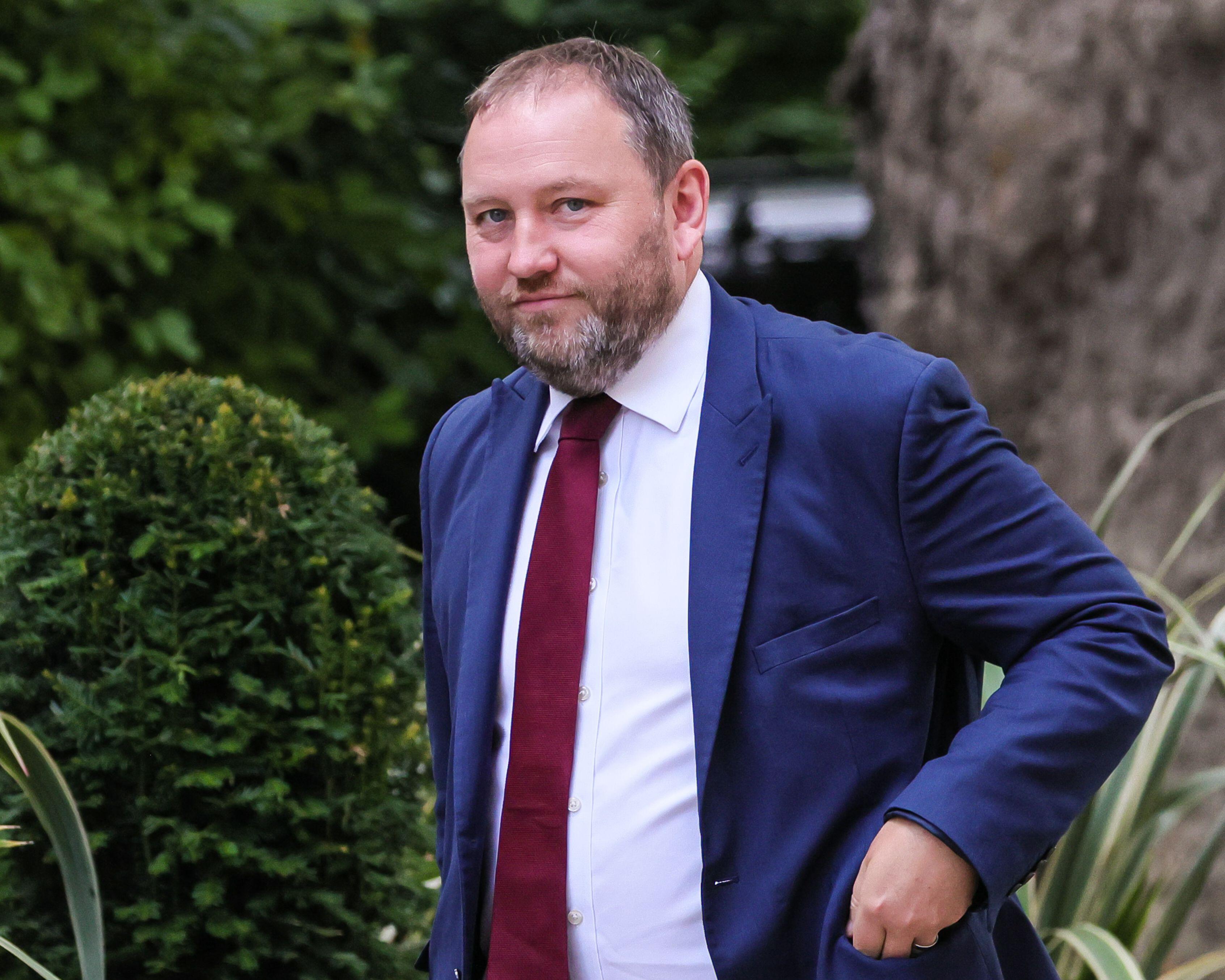 Ian Murray, Secretary of State for Scotland, MP Edinburgh South, wearing a blue suit and red tie, outside.
