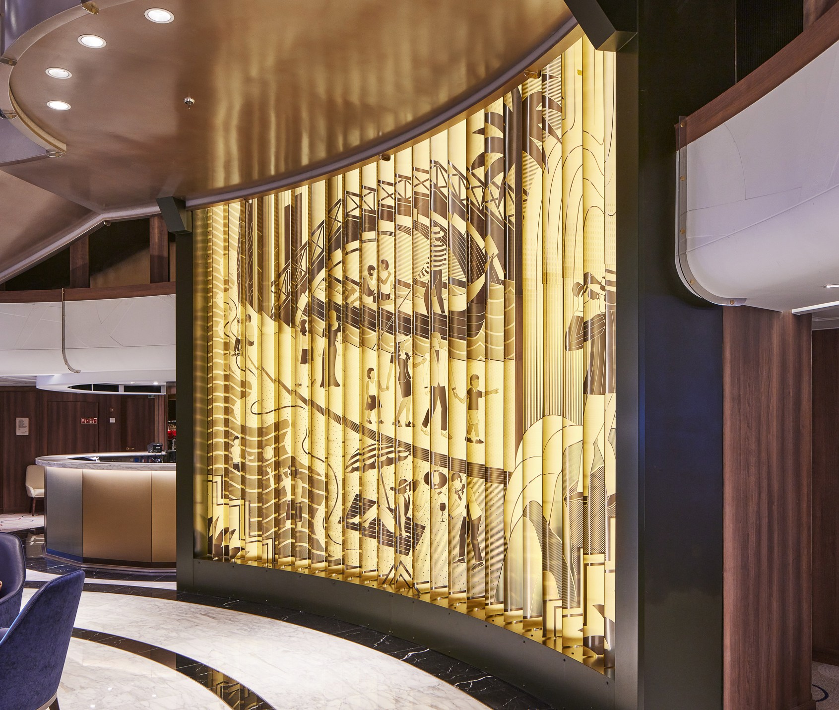 A luxurious lounge area on a cruise ship with a large, illuminated art installation depicting people in various activities.