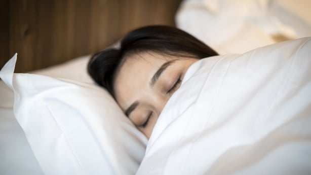 A young Asian woman is sleeping