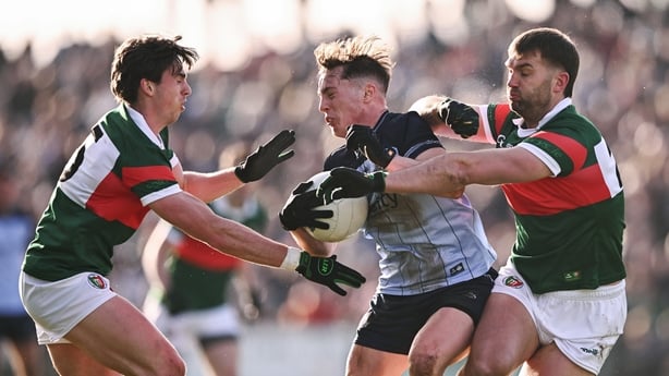1 February 2026; Conor Tyrrell of Dublin is tackled by Aidan O'Shea, righrt, and Sam Callinan of Mayo during the Allianz Football League Division 1 match between Mayo and Dublin at the Hastings Insurance MacHale Park in Castlebar, Mayo. Photo by Ben McShane/Sportsfile