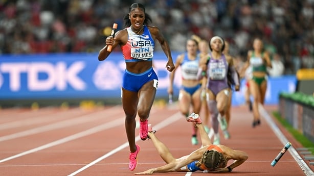 19 August 2023; Alexis Holmes of USA, left, on her way to winning the mixed 4x400m relay as Femke Bol of Netherlands falls during day one of the World Athletics Championships at the National Athletics Centre in Budapest, Hungary. Photo by Sam Barnes/Sportsfile