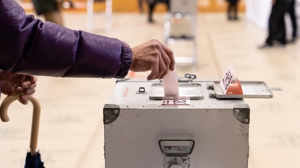 A voter casts their ballot at a polling station in Tokyo, Japan.