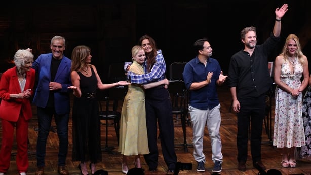 Michelle Williams and Katie Holmes embrace onstage as Mary Beth Peil, John Wesley Shipp, Mary Beth Peil, Lin-Manuel Miranda, Joshua Jackson and Busy Phillips attend the Dawson's Creek Class Reunion