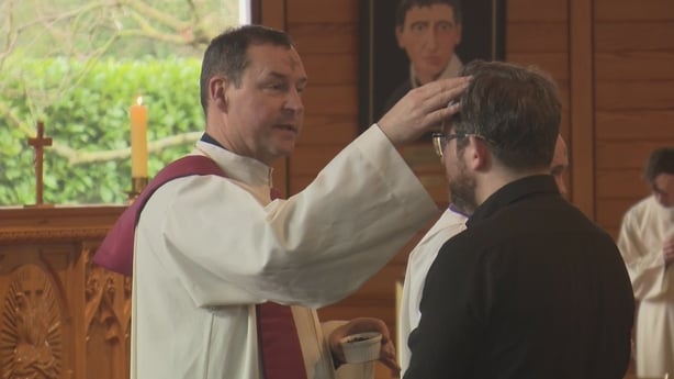 A priest giving ashes on Ash Wednesday