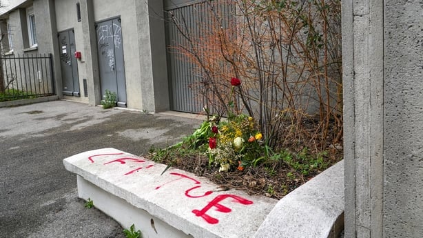 Flowers are seen placed beside garage doors