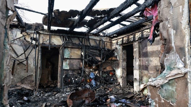 A burnt out building with the roof missing