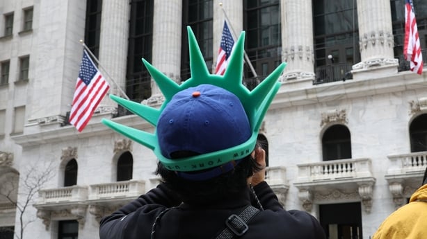  A tourist wears a Statue of Liberty-themed hat outside the New York Stock Exchange