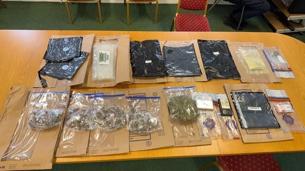 a number of clear bags containing drugs and other items displayed on a table