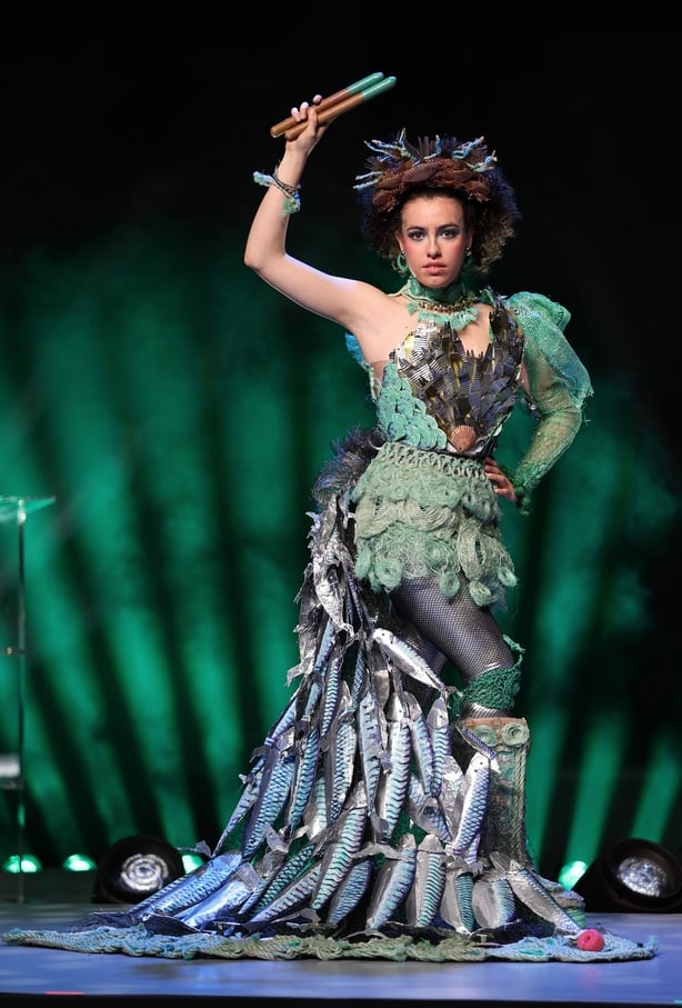 Paco Rabanne's metalwork, the structured corset and flowing ocean silhouette highlight the devastating impact of overfishing and ocean pollution, and the urgent need for marine conservation.