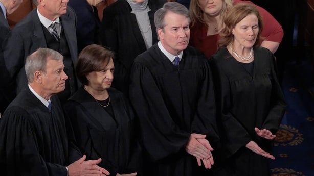 Two men and two women wearing judges robes