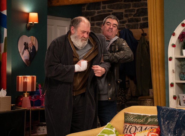 Cain manhandles a broken looking Bear in a scene from Emmerdale