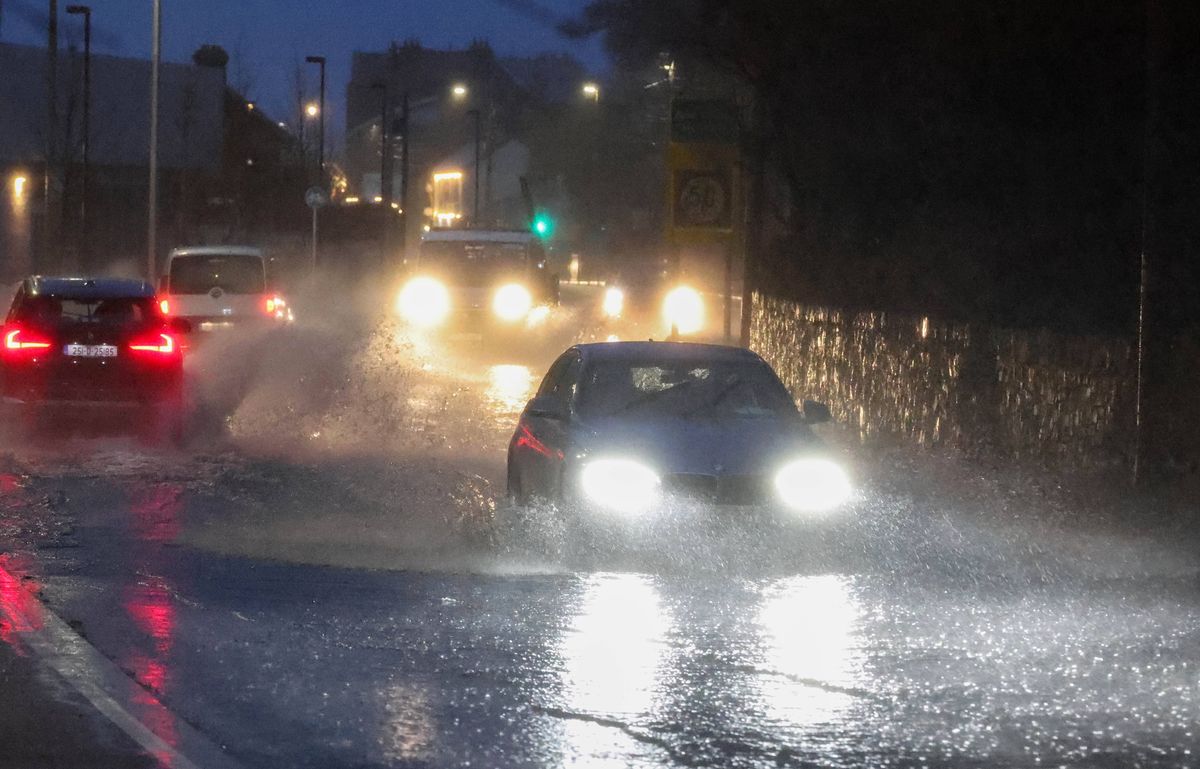 Scenes in Howth as commuters make their way to work through heavy flooding as Storm Chandra batters the country