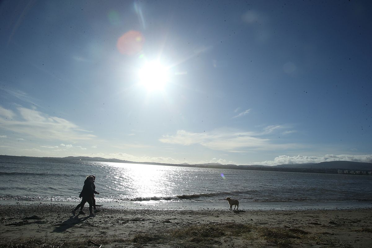 People enjoying the sun shine at Poolbeg, Dublin