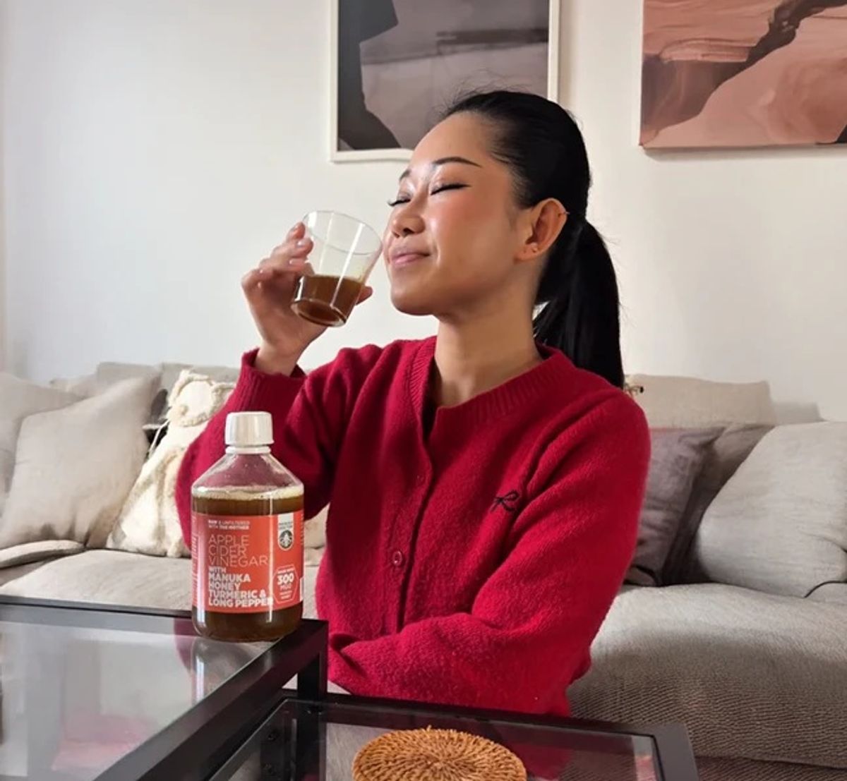 A woman drinking apple cider vinegar