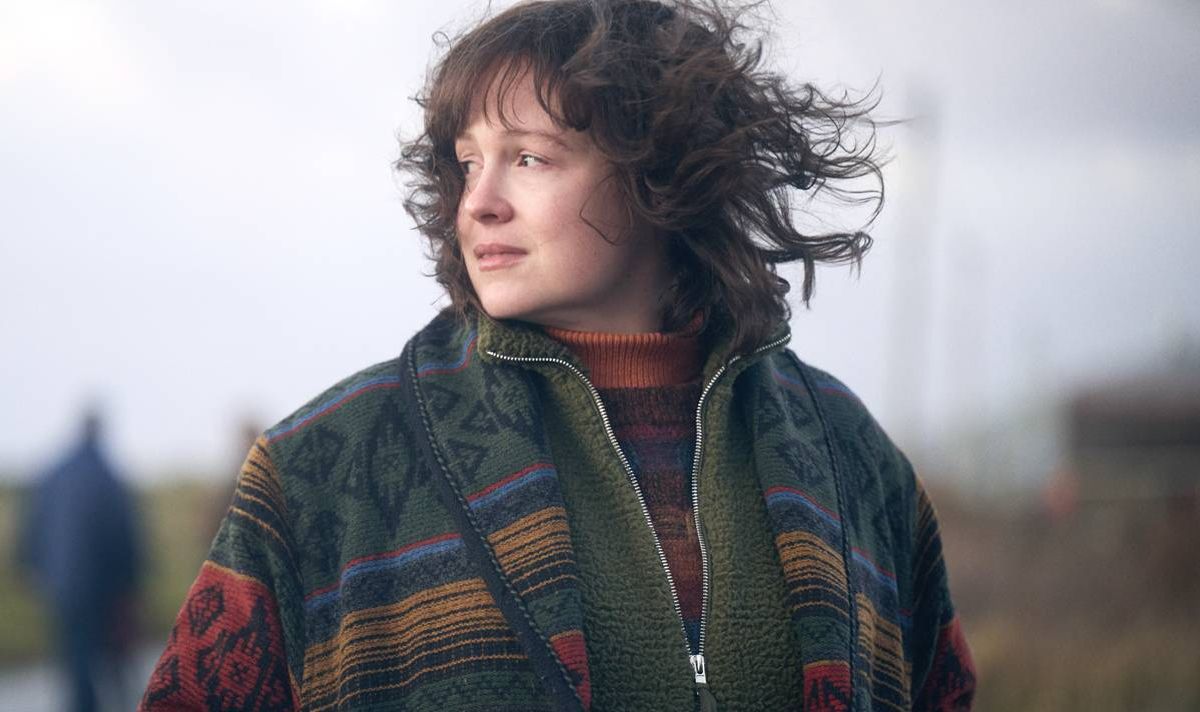 A woman looks sad as the wind blows through her hair