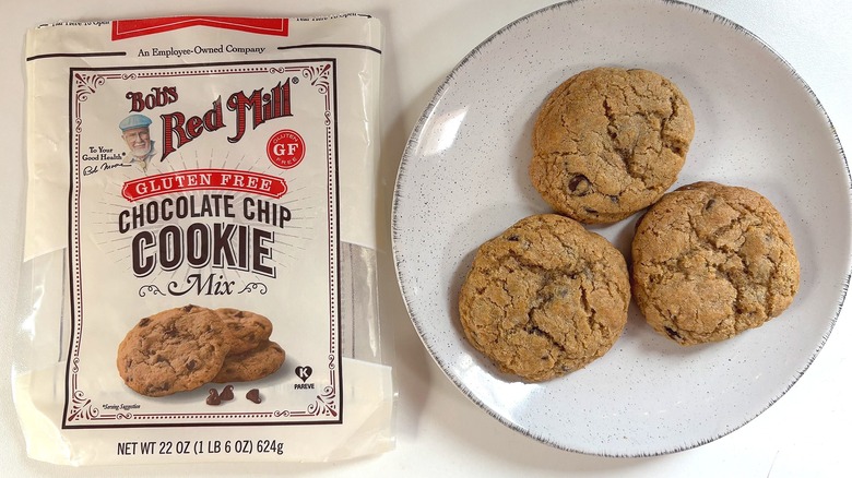 Bag of Bob's Red Mill Gluten Free chocolate chip cookie mix on table next to chocolate chip cookies on plate