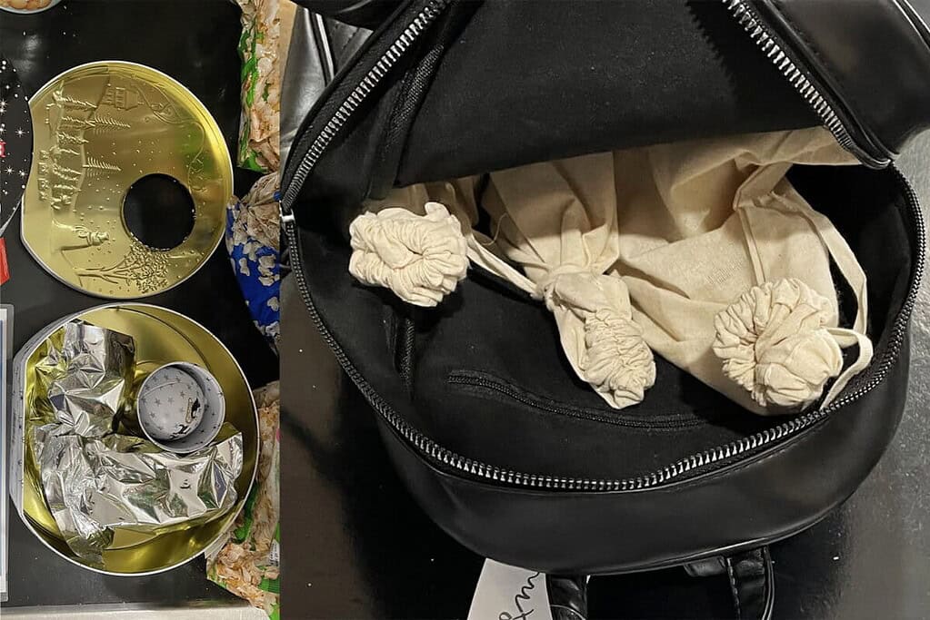 Contents of a black backpack with scattered items and a partially open zipper.