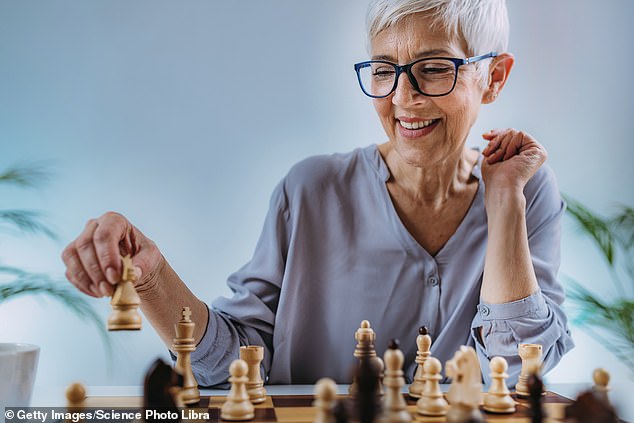 A woman playing chess. Any brain activity that stimulates the brain can ease the symptoms of dementia