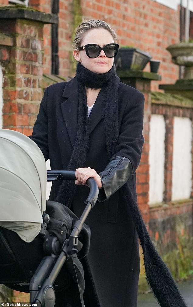 The actress, 36, cut a chic figure in a long black coat which she layered over a white jumper and floaty patterned trousers