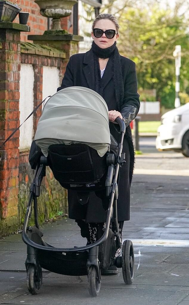 Emily Atack bundled up as she headed out on a walk with her 19-month-old son Barney on Wednesday