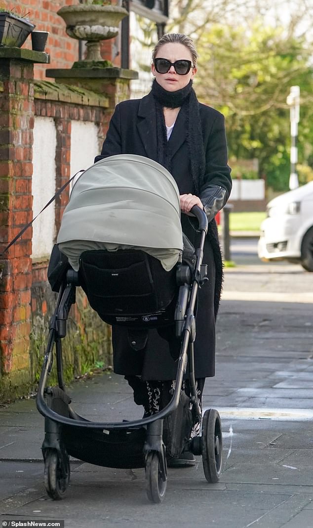 Emily Atack bundled up as she headed out on a walk with her 19-month-old son Barney on Wednesday
