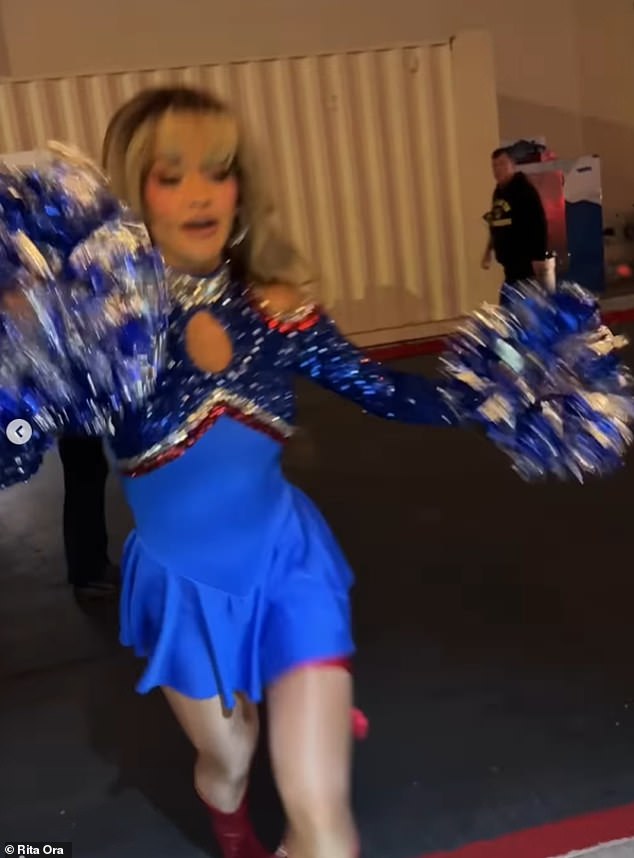 The singer, 35, looked sensational in the blue cheerleader dress which boasted a sequin blue, red and silver top detailing