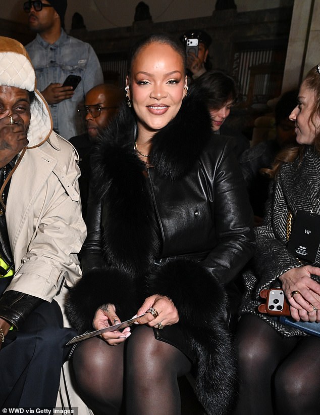 The  smiling songstress exuded pride as she cheered on her husband's fashion endeavor