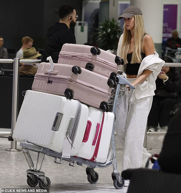 Jessy rocked a black crop top with a grey tracksuit after the long flight