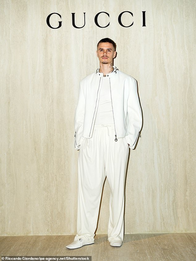 Romeo completed his look with loose, wide-leg white trousers, with the light-weight fabric blowing in the wind