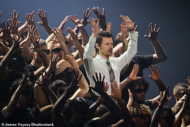 Joined by a huge group of dancers he strutted his stuff energetically in a perfectly choreographed routine, complete with spirit fingers