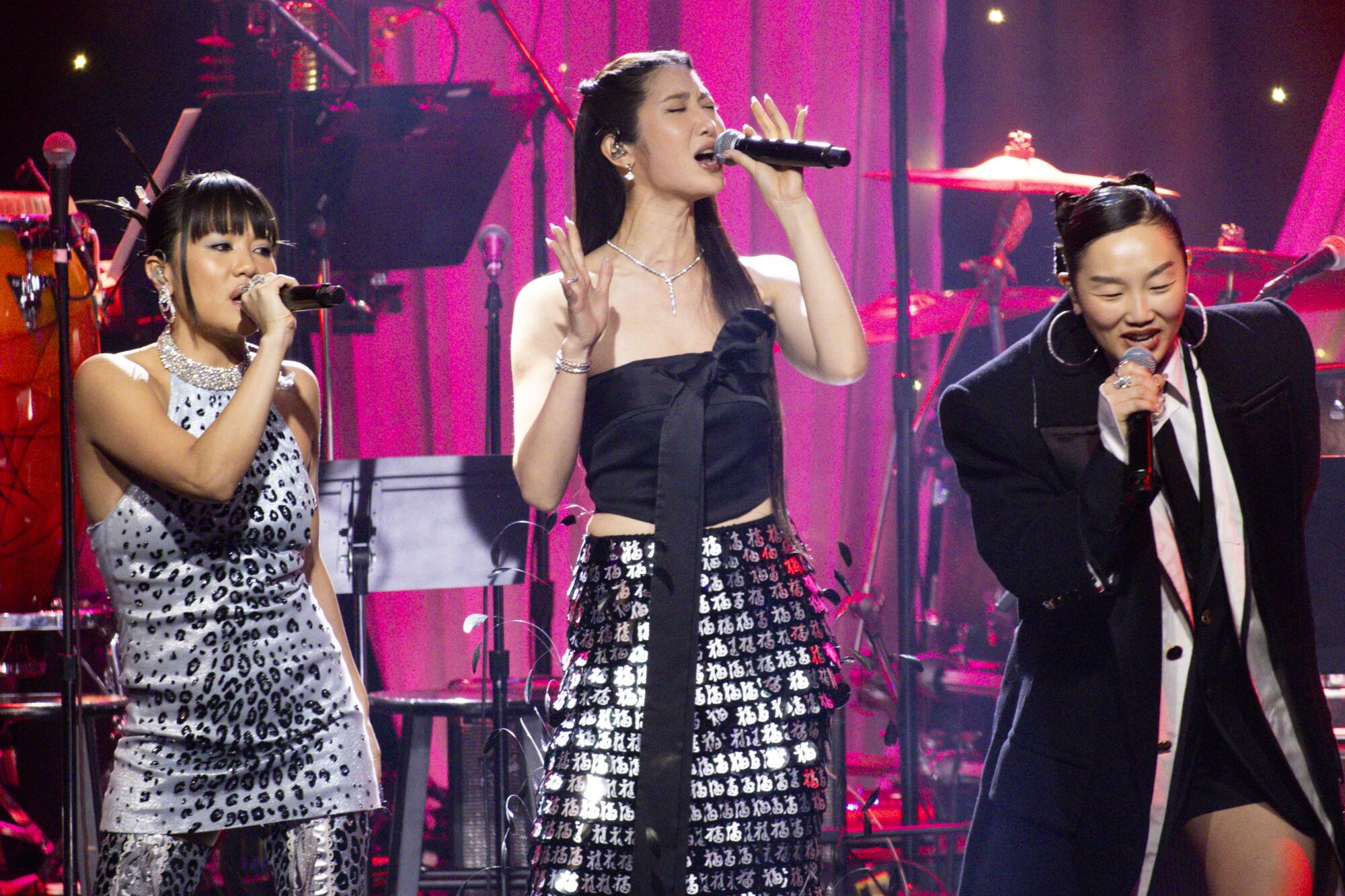 Rei Ami, from left, EJAE and Audrey Nuna of Huntr/x perform during Clive Davis' annual pre-Grammy gala at the Beverly Hilton.