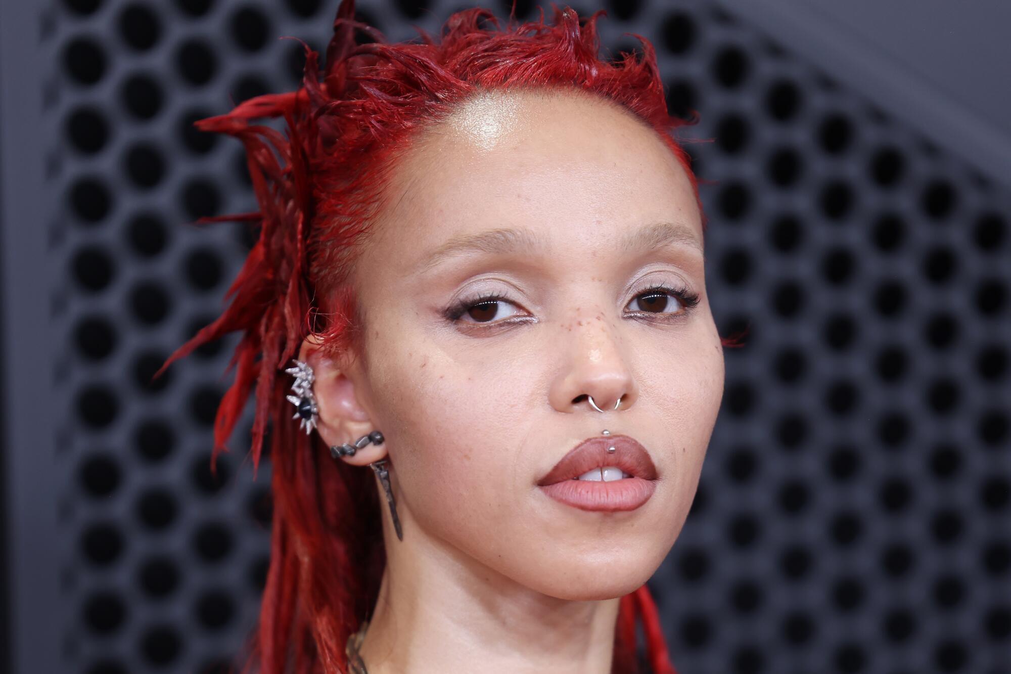 FKA Twigs poses on the Grammys red carpet. 