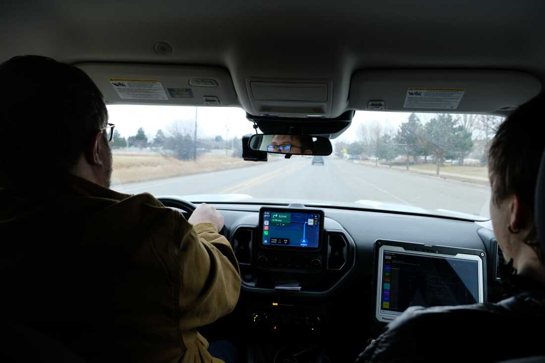 Therapist Luke Forney (driving) and responder Evan Thiessen drive to a home in Bozeman, Mont., on Jan. 9 after receiving a call about a resident having a psychiatric crisis. The mobile crisis team in Bozeman has reduced the time that police spend on mental health calls by nearly 80%.