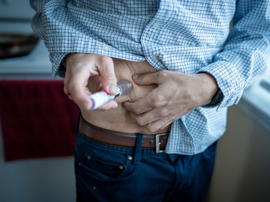 Jason Krynicki gives himself his GLP1 injection. One version of the medicine is now available in pill form, and therapists who treat eating disorders are worried it will be abused.