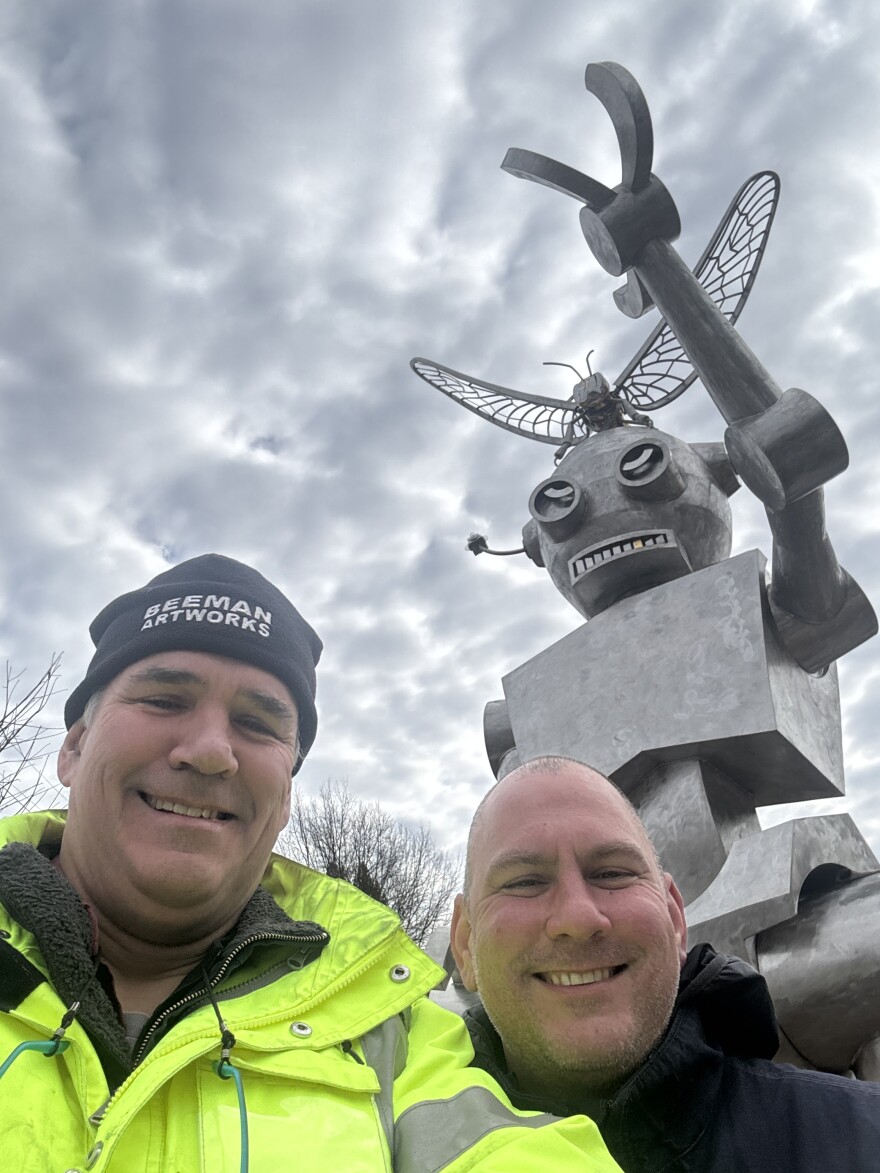 Metal sculptor and assistant