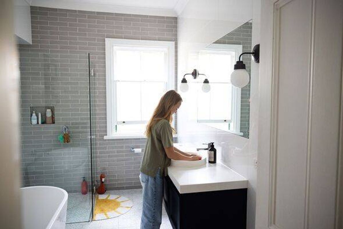 Girl Washing Hands in Contemporary Bright Bathroom