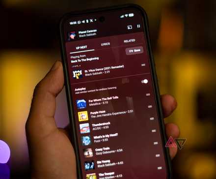 A phone displaying the YouTube Music autoplay feature on the screen