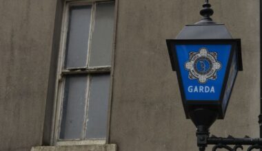 Cropped shot of courier person standing at front door, handing over a parcel to customer. Door to door courier service. Express delivery and online shopping.