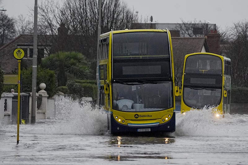 Buses make their way along Clontarf Road, Dublin, during flooding on February 5. Photograph: Brian Lawless/PA