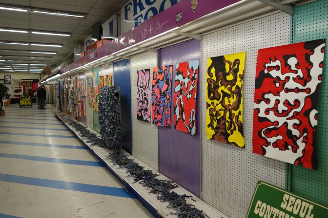 Paintings on the wall of a 99 Cent store.