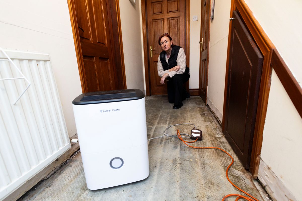 Photo shows Caroline Walsh at her home after devastating floods last week.