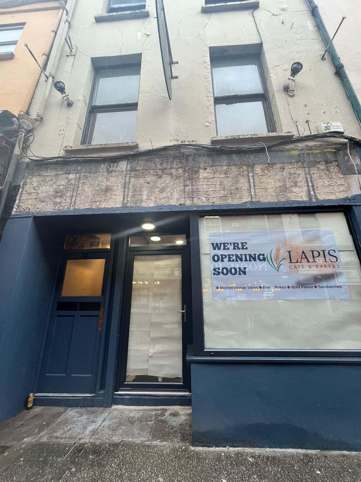 Coming soon signs before the Lapis Cafe's opening