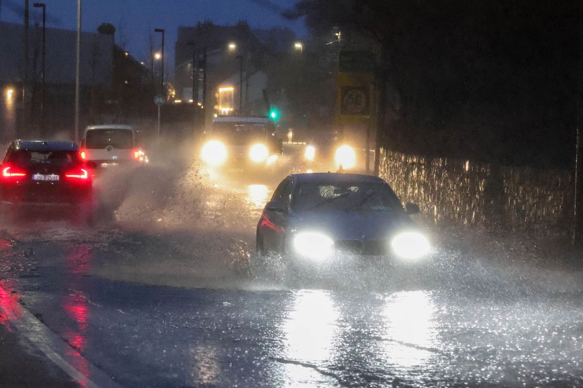 Scenes in Howth as commuters make their way to work through heavy flooding as Storm Chandra batters the country