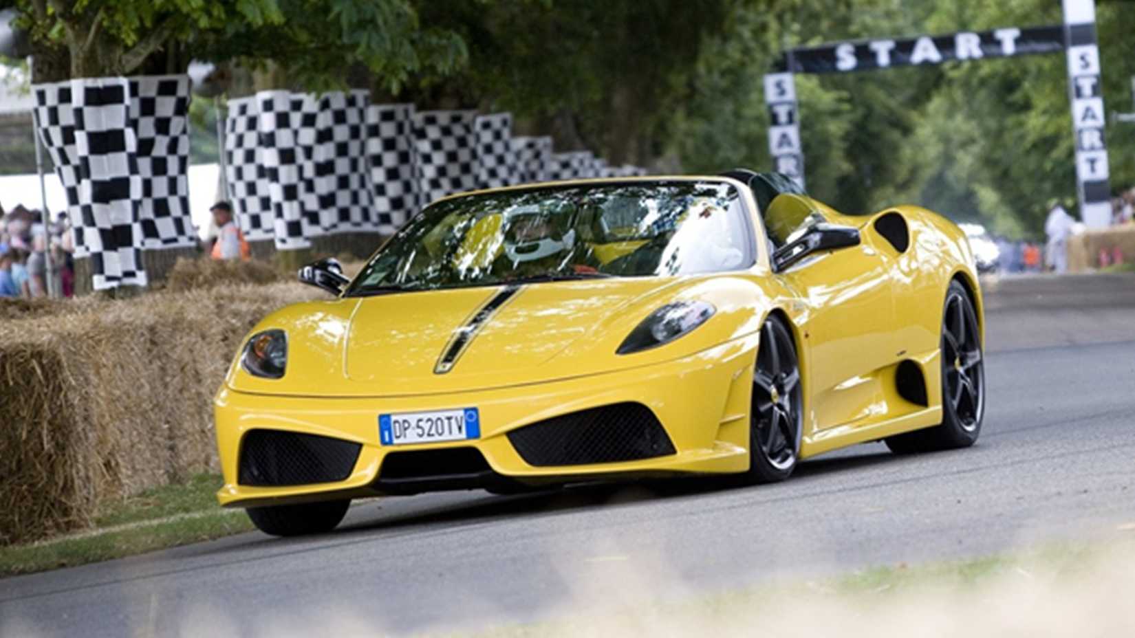 Yellow 2009 Ferrari F430 Scuderia Spider 16M on track