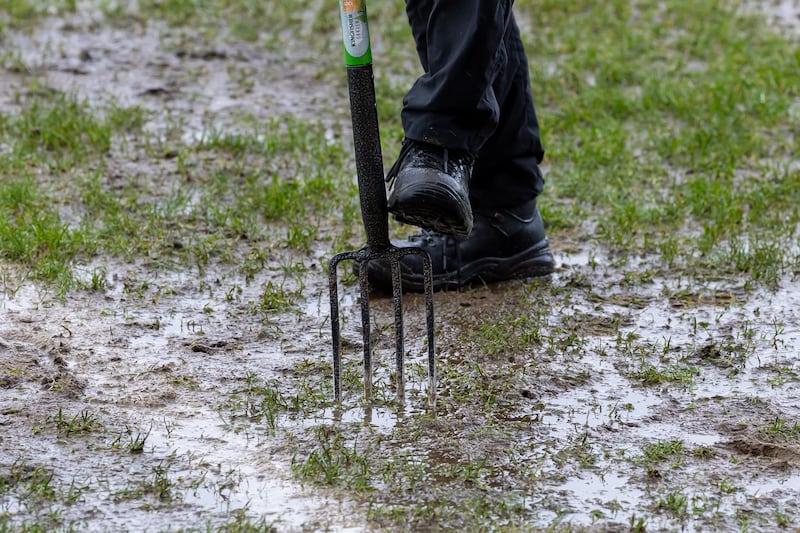 Groundsmen work on clearing water from the Athletic Grounds pitch before Armagh-Donegal. Photograph: Morgan Treacy/Inpho