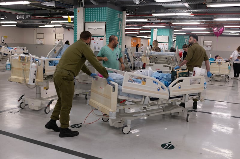 Hospital staff move patients to a parking lot shelter at the Ichilov medical center in Tel Aviv, Israel, on Saturday. Photograph: Kobi Wolf/Bloomberg