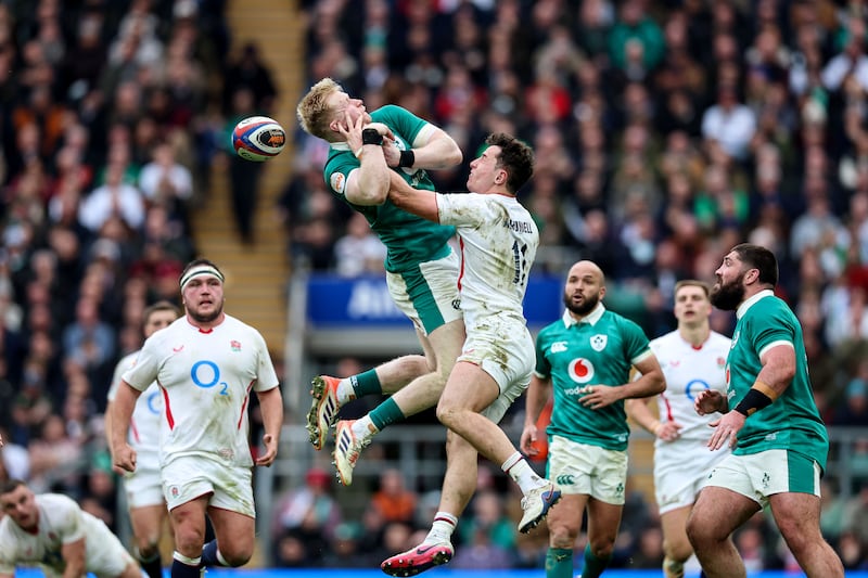 Ireland's Jamie Osborne competes in the air against England's Henry Arundell. Photograph: Billy Stickland/Inpho