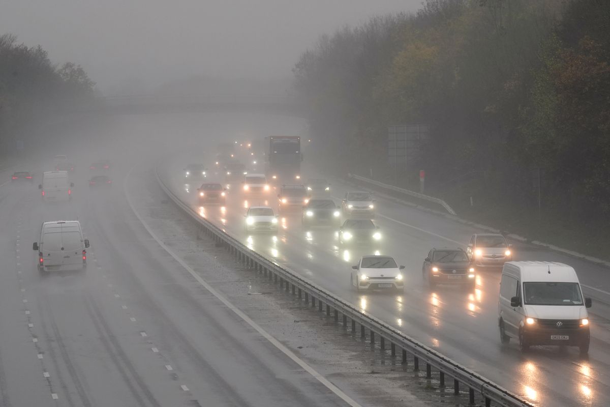 Motorists travel through rain and spray on a motorway (file photo)